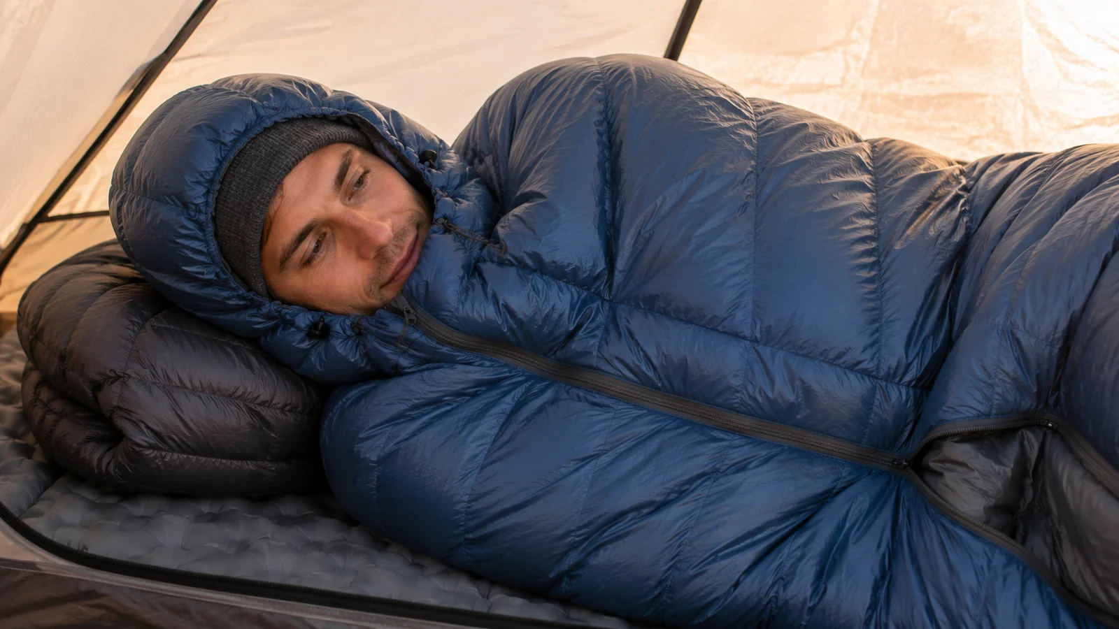 A side sleeper settling into a roomier ultralight bag with the draft collar visible